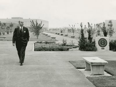 Photograph of President Arnold Joyal walking across the Fresno State campus, circa 1958.